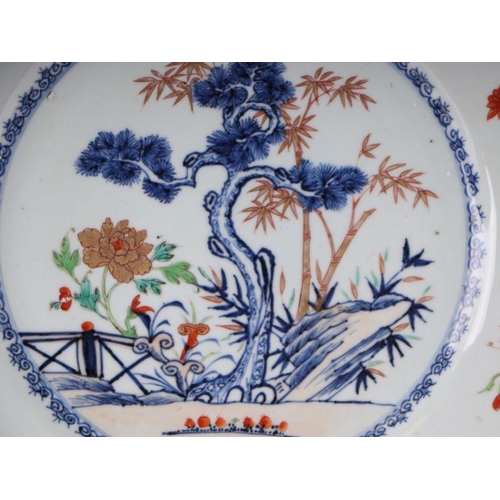 882 - A Chinese famille rose charger decorated with a fir tree and a terrace, 32cm diameter.