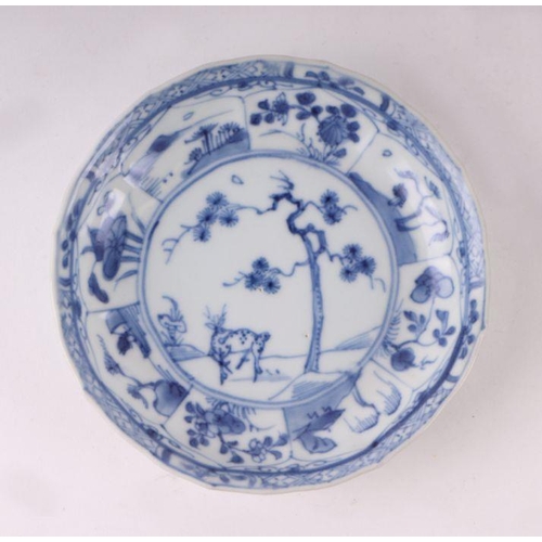 883 - A pair of Chinese blue and white dishes decorated with figures in a garden, four character blue mark... 