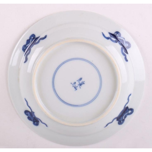 883 - A pair of Chinese blue and white dishes decorated with figures in a garden, four character blue mark... 