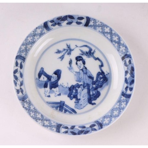 883 - A pair of Chinese blue and white dishes decorated with figures in a garden, four character blue mark... 