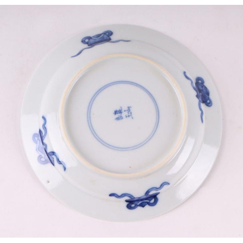 883 - A pair of Chinese blue and white dishes decorated with figures in a garden, four character blue mark... 