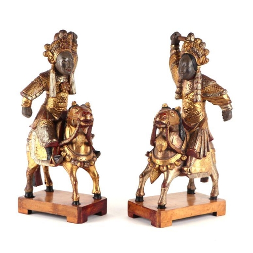 886 - A pair of Chinese giltwood figures on horseback, 40cm high.