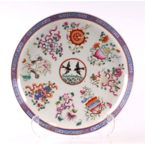 888 - A Chinese famille rose plate decorated with a pair of birds within a border of precious objects, red... 