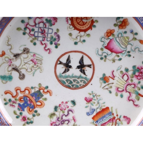 888 - A Chinese famille rose plate decorated with a pair of birds within a border of precious objects, red... 