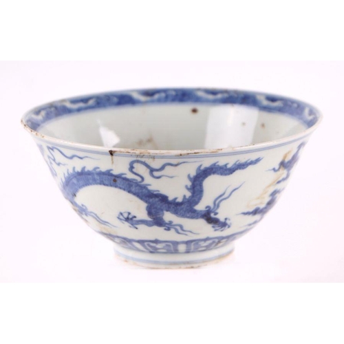 892 - A Chinese blue and white footed bowl decorated with dragons amongst clouds with six character blue m... 