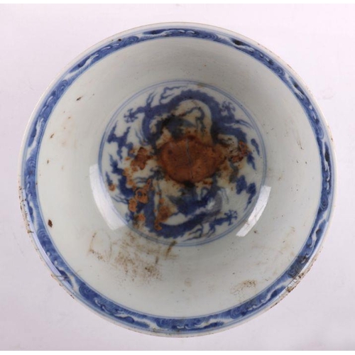 892 - A Chinese blue and white footed bowl decorated with dragons amongst clouds with six character blue m... 