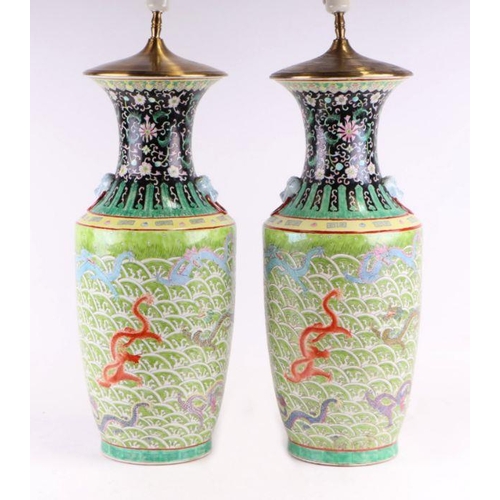 898 - A pair of Chinese famille vert vase table lamps decorated with dragons amongst waves; six character ... 