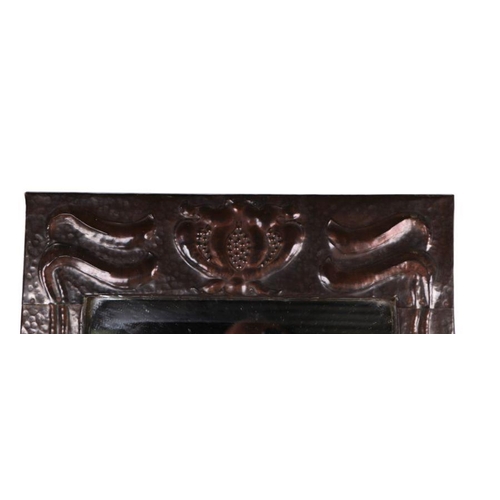 912 - An Arts & Crafts rectangular copper wall mirror in the manner of Liberty, with repousse and enamel d... 