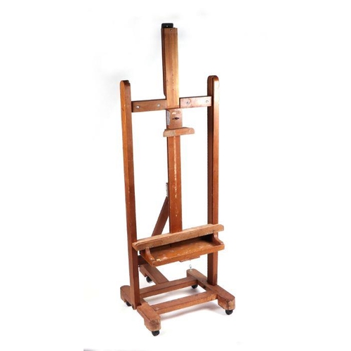 914 - A large adjustable artist's easel, 60cm wide.