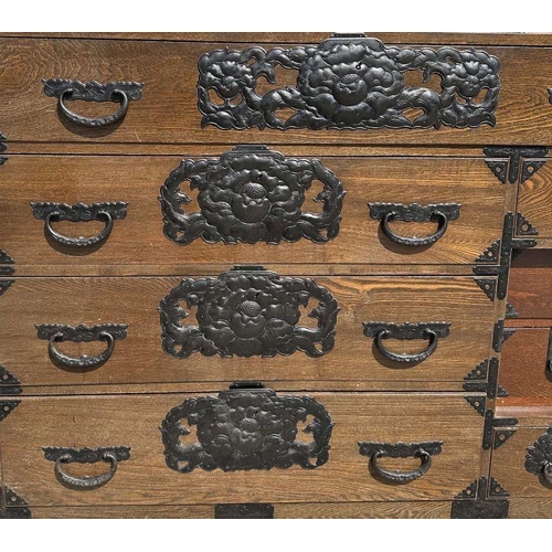 932 - A Korean chest with an arrangement of six drawers and a cupboard with fitted interior, with iron han... 