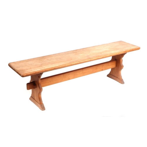 936 - A modern pine bench, on shaped end supports joined by a stretcher. 150cm wide