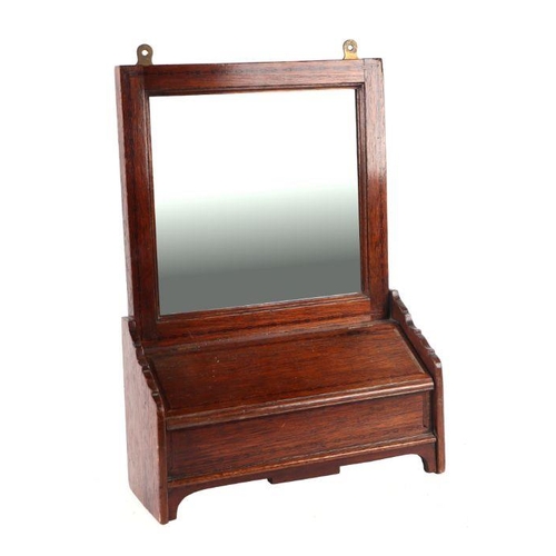 942 - An Edwardian oak wall mirror with candle box beneath, 33cms wide.