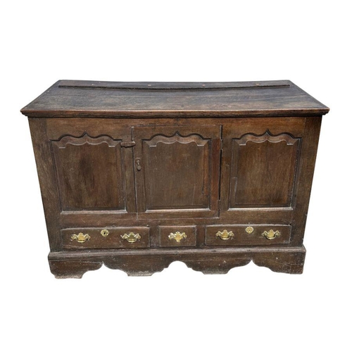 947 - A 19th century oak dresser base with three panelled doors above three drawers, on a shaped apron, 14... 