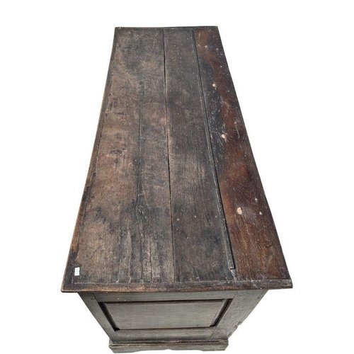 947 - A 19th century oak dresser base with three panelled doors above three drawers, on a shaped apron, 14... 