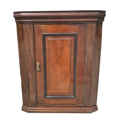 952 - A 19th century oak wall hanging corner cupboard.