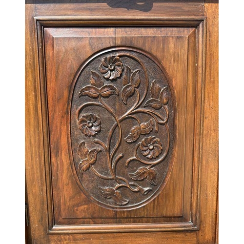 960 - An Edwardian walnut bookcase on cupboard with twin swan necked arched pediment above a pair of glaze... 