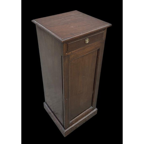 967 - An Edwardian mahogany pot cupboard of slender proportions with single drawer above a fielded panelle... 