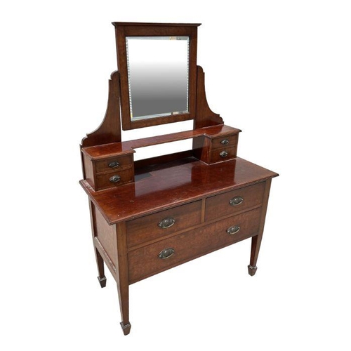 970 - An Edwardian mahogany dressing chest, the super structure with central mirror flanked by two banks o... 