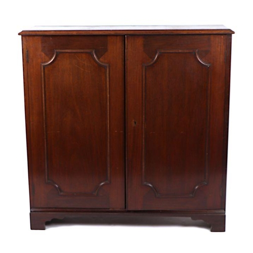 977 - A pair of Victorian mahogany bookcases, each with a pair of panelled doors enclosing shelves, on bra... 