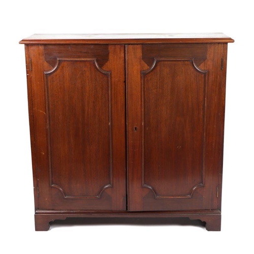 977 - A pair of Victorian mahogany bookcases, each with a pair of panelled doors enclosing shelves, on bra... 