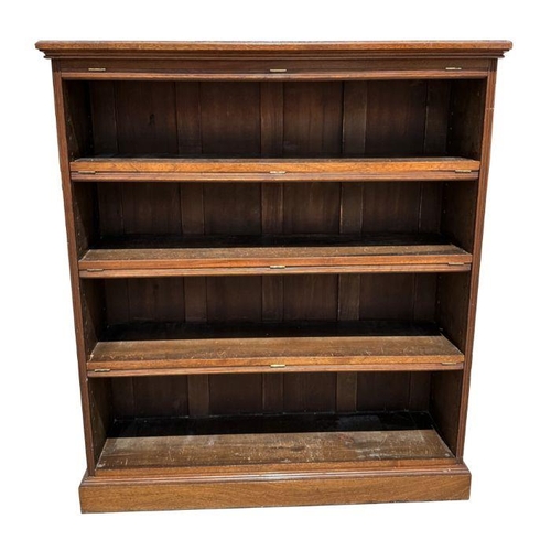 986 - A late Victorian / Edwardian walnut open bookcase with an arrangement of three shelves with dust pro... 