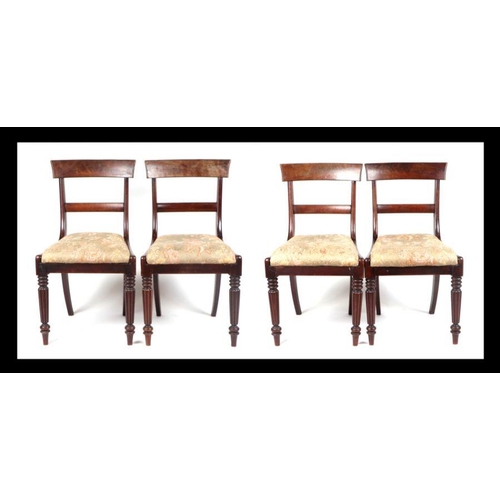 988 - A set of four Willian IV mahogany dining chairs, having drop in seats and reeded tapering legs. (4)