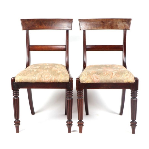 988 - A set of four Willian IV mahogany dining chairs, having drop in seats and reeded tapering legs. (4)