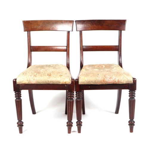 988 - A set of four Willian IV mahogany dining chairs, having drop in seats and reeded tapering legs. (4)