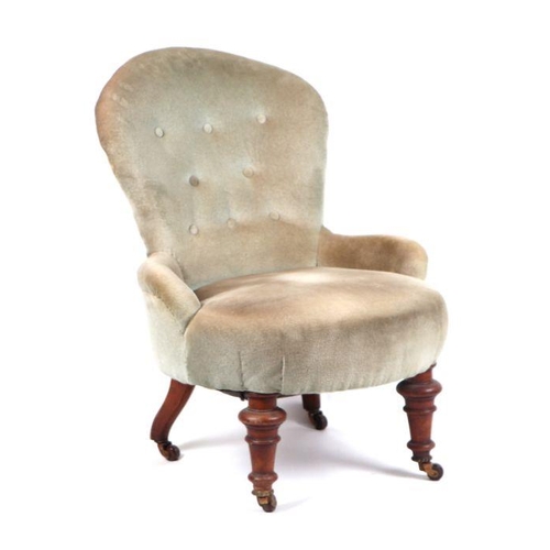 989 - A Victorian button backed upholstered tub chair on turned front legs.