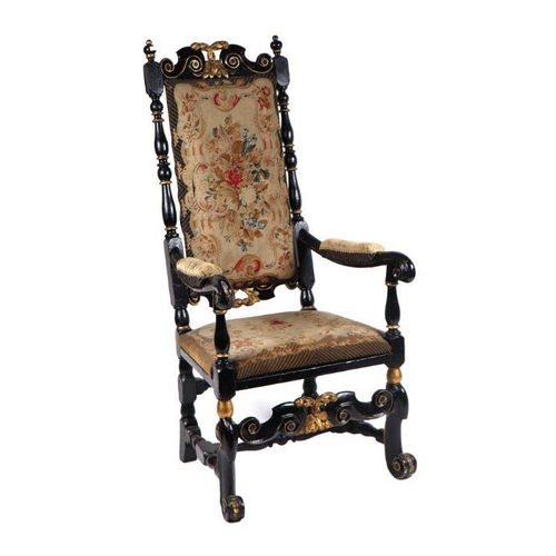 991 - A 17th century style ebonised and gilt show wood upholstered armchair with scroll arms and feet.