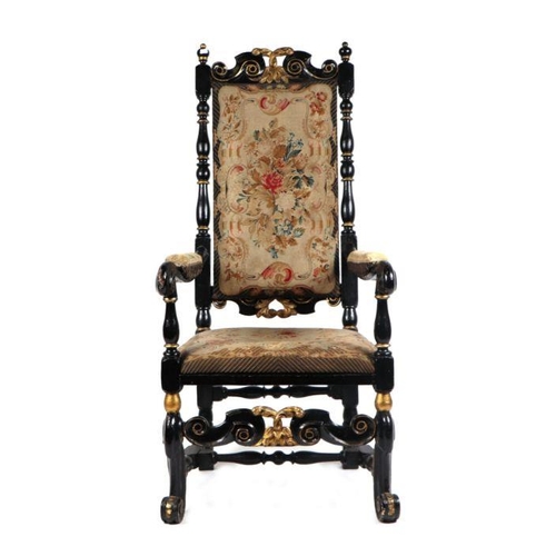 991 - A 17th century style ebonised and gilt show wood upholstered armchair with scroll arms and feet.