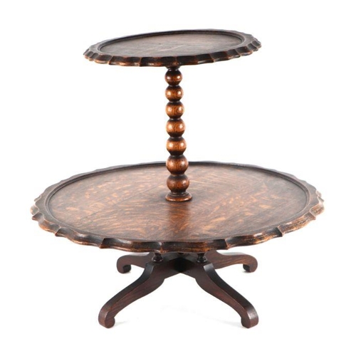 998 - An early 20th century oak two-tier Lazy Susan on bobbin turned column and quatrefoil base, 43cm high... 