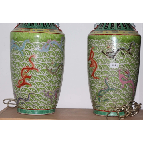 898 - A pair of Chinese famille vert vase table lamps decorated with dragons amongst waves; six character ... 