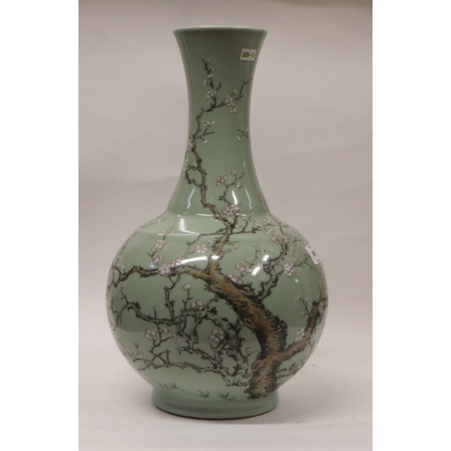 894 - A large Chinese celadon ground vase decorated with flowering prunus with six character black mark to... 