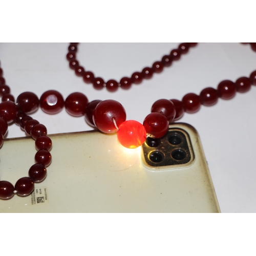 713 - A graduated cherry amber bead necklace, 48g, approx 72cm long.