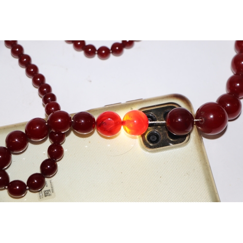 713 - A graduated cherry amber bead necklace, 48g, approx 72cm long.