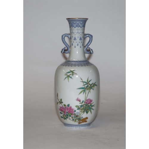 760 - A Chinese republic style famille rose two-handled vase decorated with bamboo and roses, four charact... 