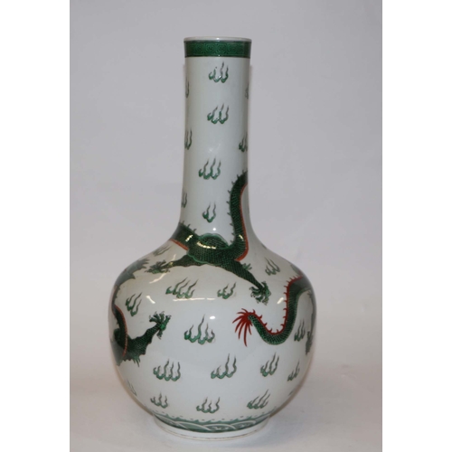 761 - A Chinese famille verte bottle vase decorated with dragons chasing a flaming pearl, blue character m... 