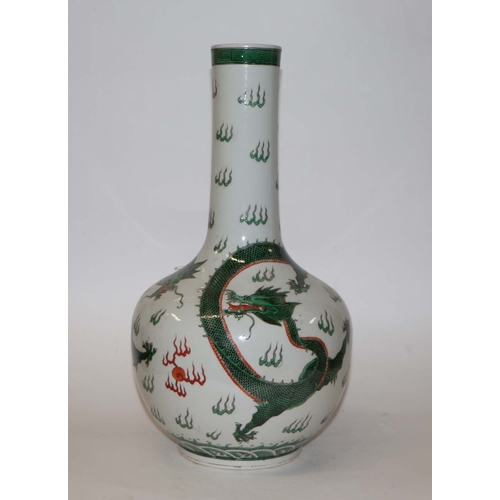 761 - A Chinese famille verte bottle vase decorated with dragons chasing a flaming pearl, blue character m... 