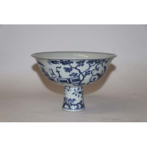 807 - A Chinese blue and white stem cup decorated with figures within a garden scene, 17cm diameter