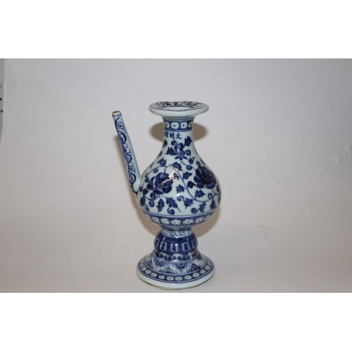 809 - A Chinese blue and white wine or sake ewer decorated with scrolling foliage and cut flowers, 20cm hi... 