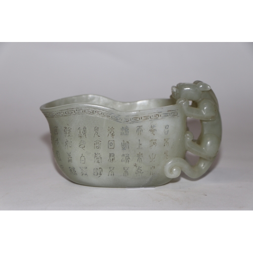 868 - A late Chinese Republic jade vessel decorated with calligraphy and having a carved dragon handle, 13... 