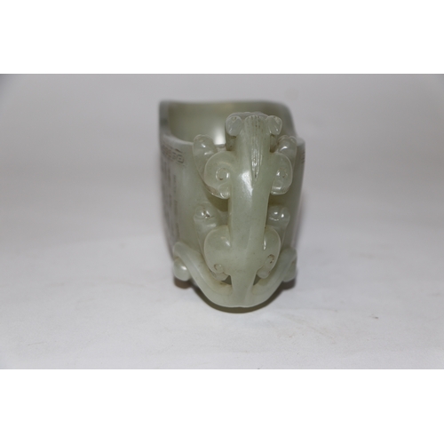 868 - A late Chinese Republic jade vessel decorated with calligraphy and having a carved dragon handle, 13... 