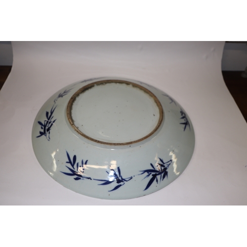 881 - A large Chinese blue and white shallow bowl decorated with flowering foliage, six character mark to ... 