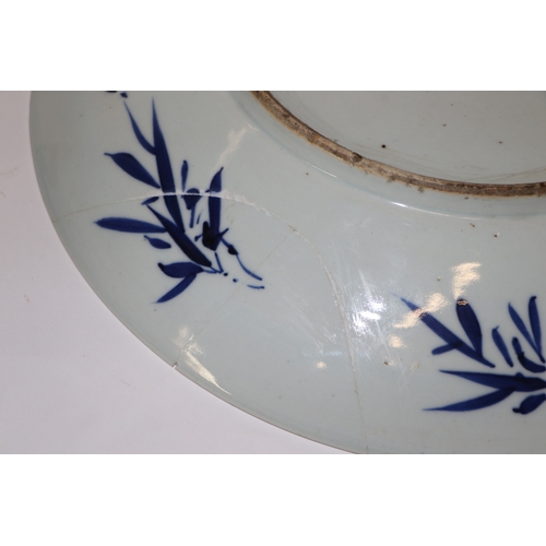 881 - A large Chinese blue and white shallow bowl decorated with flowering foliage, six character mark to ... 