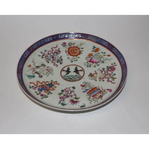 888 - A Chinese famille rose plate decorated with a pair of birds within a border of precious objects, red... 