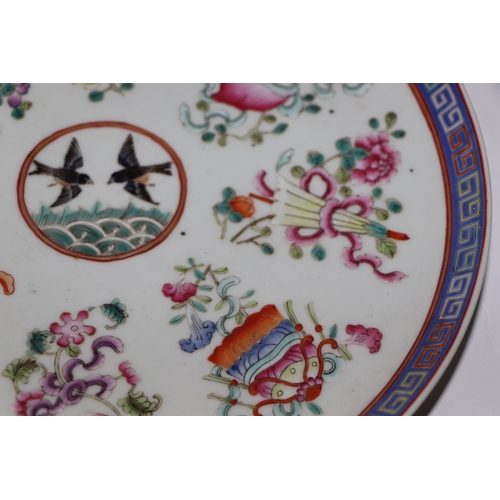 888 - A Chinese famille rose plate decorated with a pair of birds within a border of precious objects, red... 