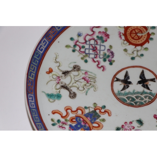 888 - A Chinese famille rose plate decorated with a pair of birds within a border of precious objects, red... 