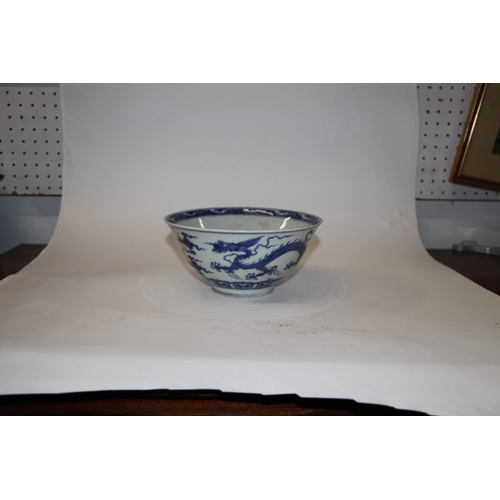 892 - A Chinese blue and white footed bowl decorated with dragons amongst clouds with six character blue m... 