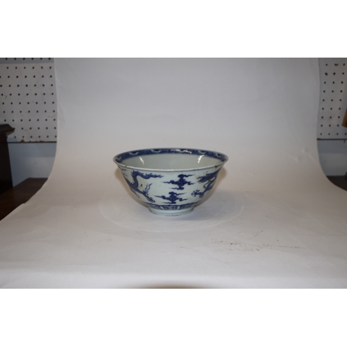 892 - A Chinese blue and white footed bowl decorated with dragons amongst clouds with six character blue m... 